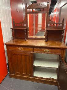 an antique Victorian or Edwardian mirror-back chiffonier sideboard .