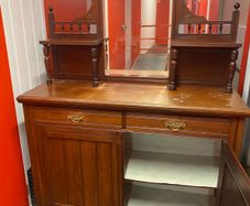 an antique Victorian or Edwardian mirror-back chiffonier sideboard .