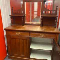 an antique Victorian or Edwardian mirror-back chiffonier sideboard .