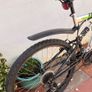 Rockway mountain bike silver and black frame with green accents and a full suspension system. Image 2