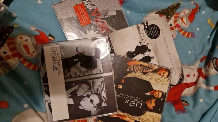 bag of U2 promo CD singles, CD albums and DVD sets