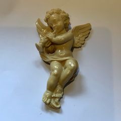 Vintage wall-mounted resin figurine of a cherub playing a trumpet