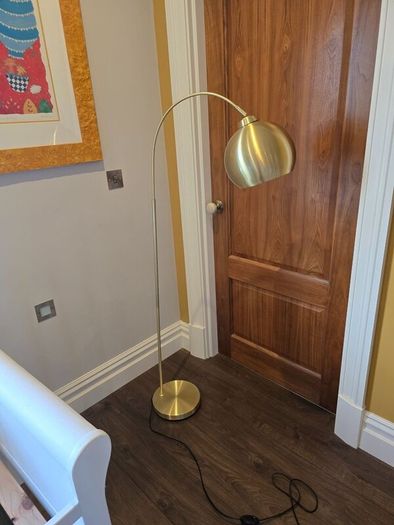 Gold arc free standing lamp