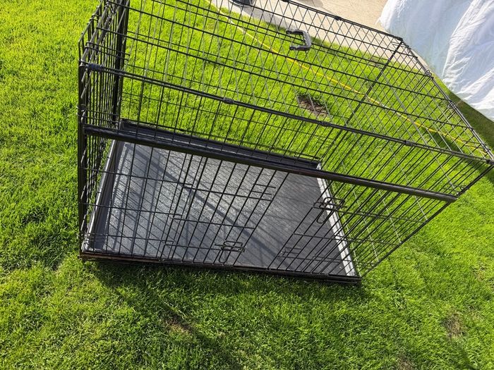 XL dog crate opens up by sliding doors at front and side. Read caption