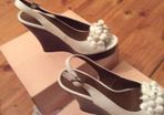 White leather wedges with floral detail