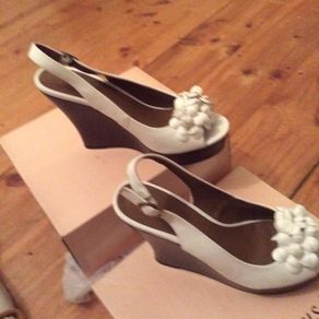 White leather wedges with floral detail