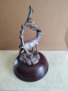This magnificent stag ornament perfectly captures the proud stance of the  and will make an eye-catching focal point in any room SET ON DARK WOOD DOME.
