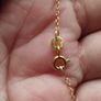 An elegant 925 sterling silver pendant on a chain. Image 2