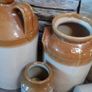 Collection of Eight Antique Stoneware Jars including Two Antique Hot Water Bottles Image 7