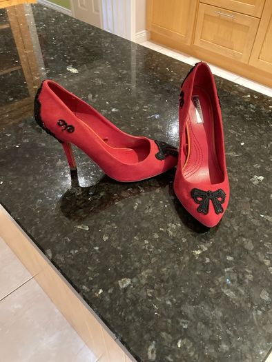 Red high heeled shoes with black lace