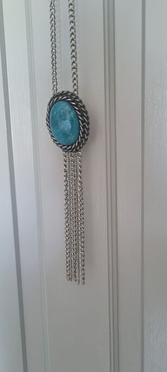 Long necklace, with turquoise centrepiece and fringe