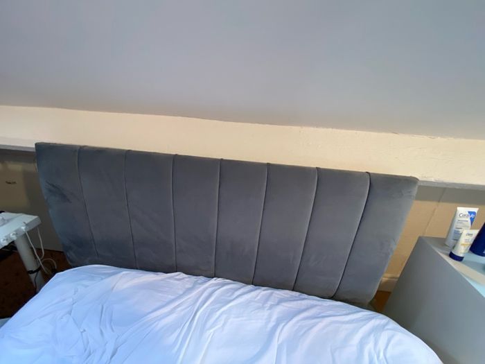 Grey double bed and mattress