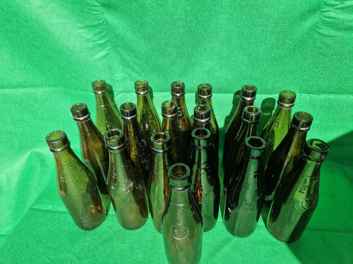 24 Antique 1/2 pint bottles in crate