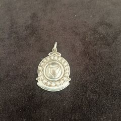 A silver medal or pendant depicting the Irish harp
