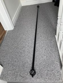 Black metal curtain rod with decorative ends