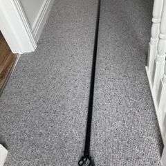 Black metal curtain rod with decorative ends