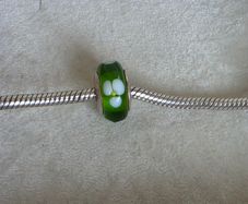 Pandora green glass charm with white flower design very good condition hallmarked