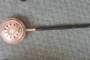 brass and copper Victorian bed warmer .