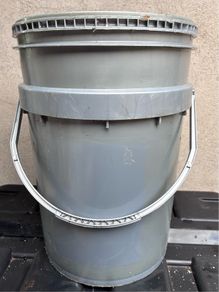 Tall grey plastic bucket