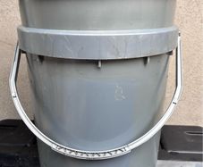 Tall grey plastic bucket