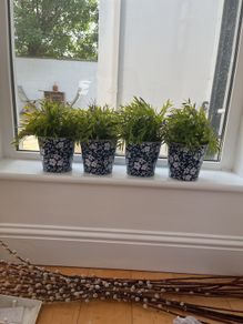 faux plants with patterned tin containers