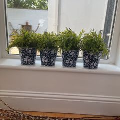faux plants with patterned tin containers