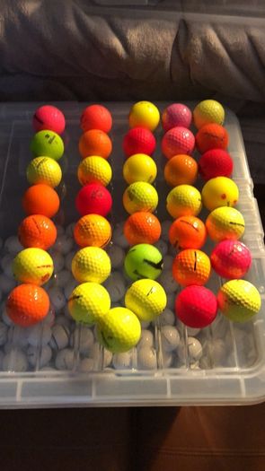 Box of coloured golf balls