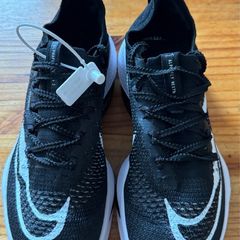 Nike Air Zoom Alphafly NEXT% 2 marathon racing shoes in black and white.