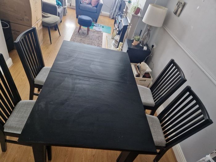 Black dining table with four chairs