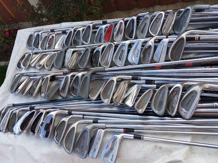 A selection of golf clubs and bags. All right handed clubs.