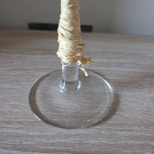 A tall clear glass candle holder