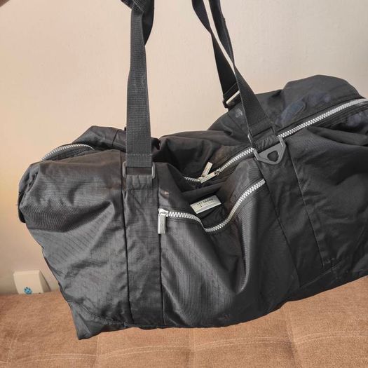 Large black expandable travel bag with shoulder strap