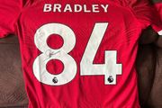 Conor Bradley signed Liverpool jersey