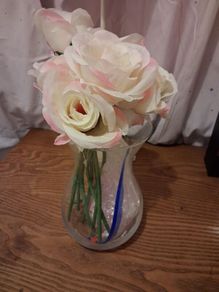 Artificial pink roses and vase