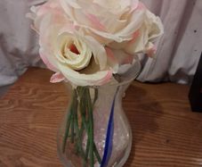 Artificial pink roses and vase