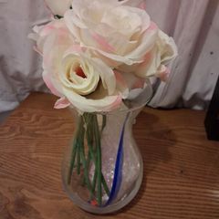 Artificial pink roses and vase