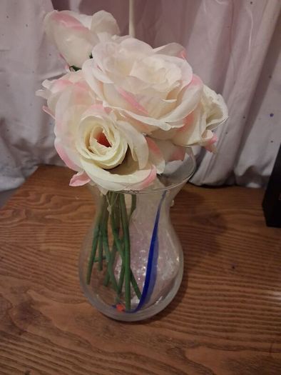 Artificial pink roses and vase