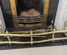 Brass fireplace fender and companion set