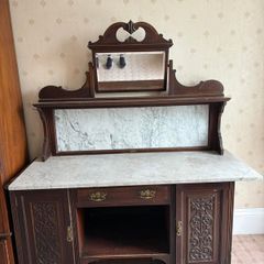 late Victorian or Edwardian mahogany mirror-back washstand featuring a white Carrara marble top and a matching marble splashback gallery.
