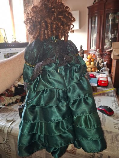 Vintage Large Victorian-style collectible Porcelain Doll featuring curly reddish-brown hair and a multi-layered emerald green satin and lace dress