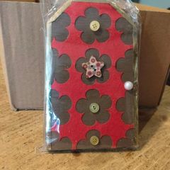 handcrafted wooden  Fairy door with red cardstock, brown flower cutouts, and decorative buttons.  various buttons acting as handles or embellishments.