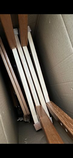 2 wooden chairs and a wall clock