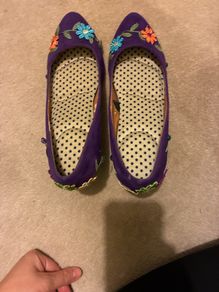 Decorated purple shoes with flowers and leaves