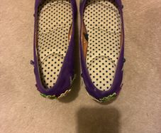 Decorated purple shoes with flowers and leaves