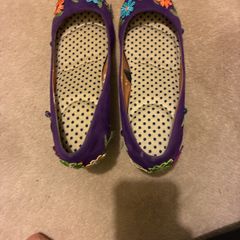 Decorated purple shoes with flowers and leaves