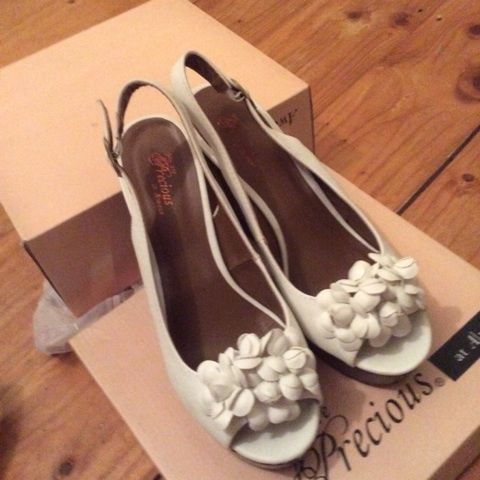White leather wedges with floral detail