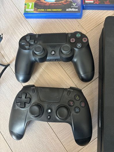 Sony PlayStation 4 console with two controllers and three games