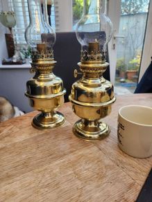 Matching pair of brass oil lamps.