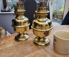 Matching pair of brass oil lamps.