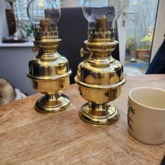 Matching pair of brass oil lamps.